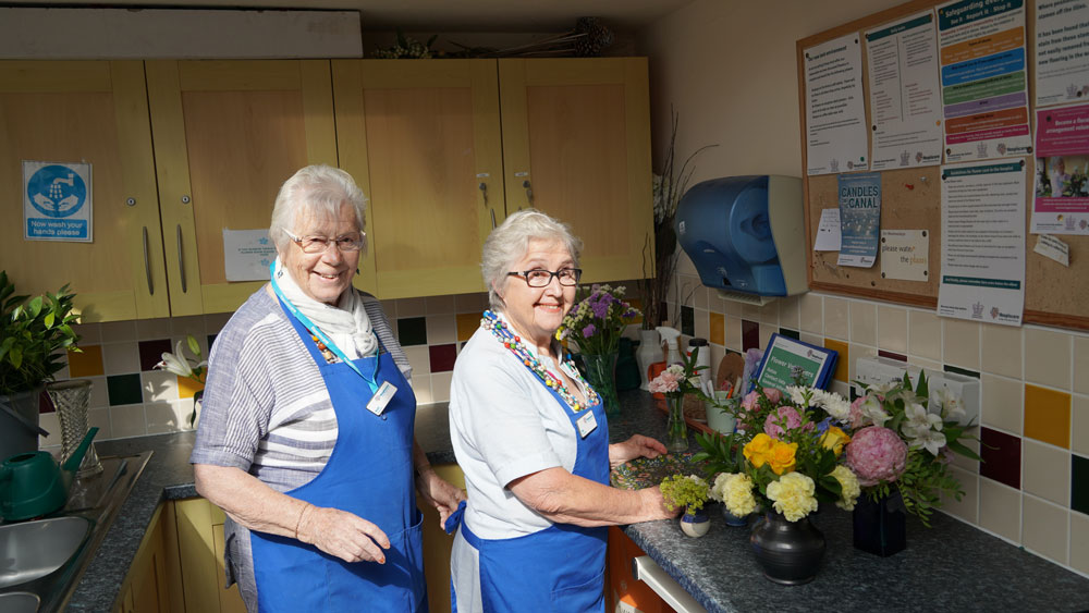Hospiscare flower volunteers Mo and Ruth looking at the camera