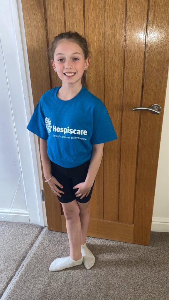 A young girl wearing a Hospiscare t-shirt