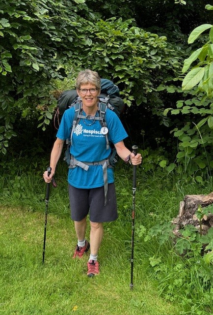 A woman in walking gear with Nordic sticks