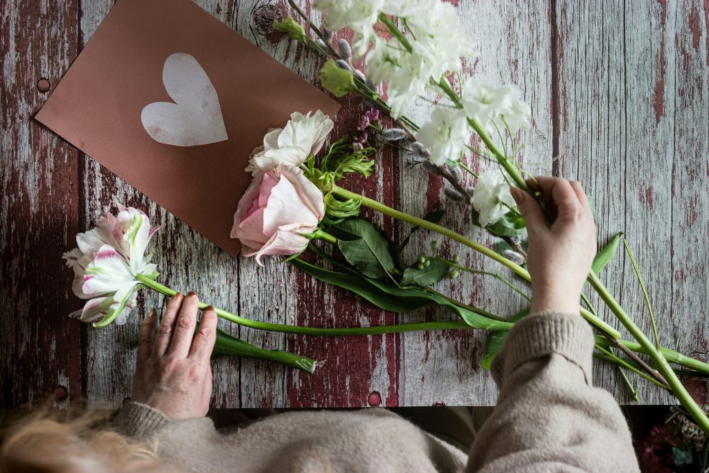 A bird's eye view of flowers and a card with a heart