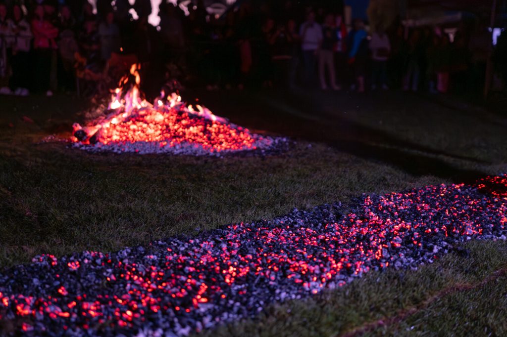 A glowing runway of embers for the Hospiscare Firewalk