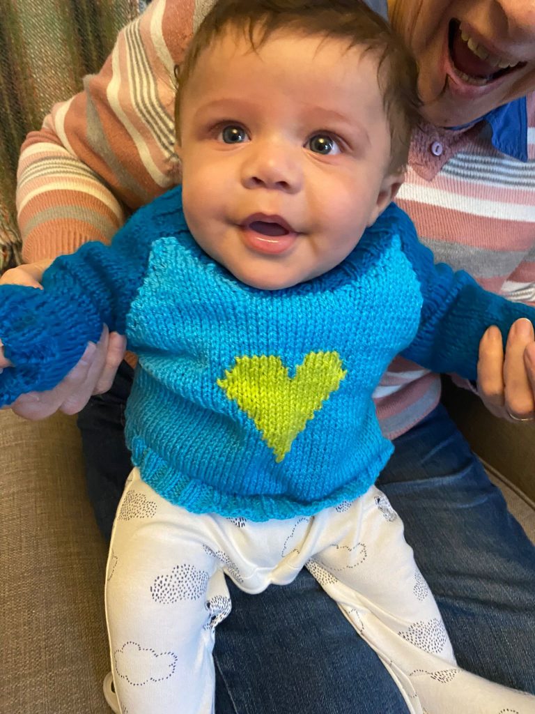 Baby boy in blue knitted jumper