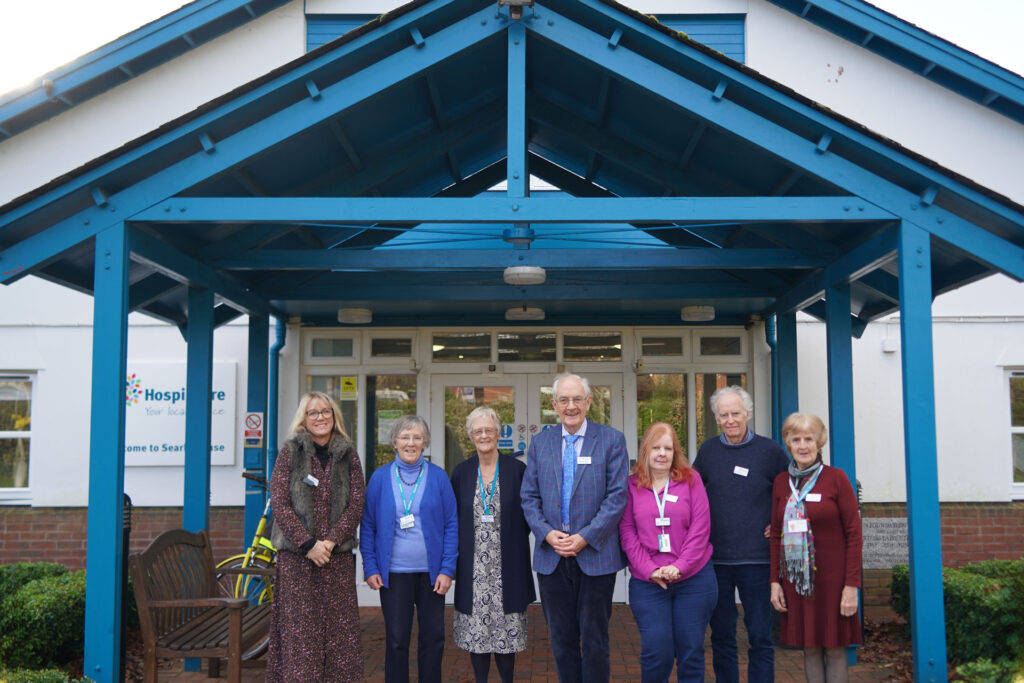 A group of people gathered in front of Hospiscare